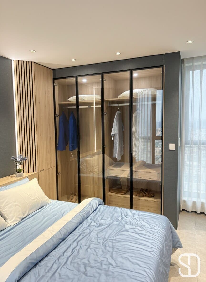 Bedroom wardrobe with smoked-glass doors over an oak interior